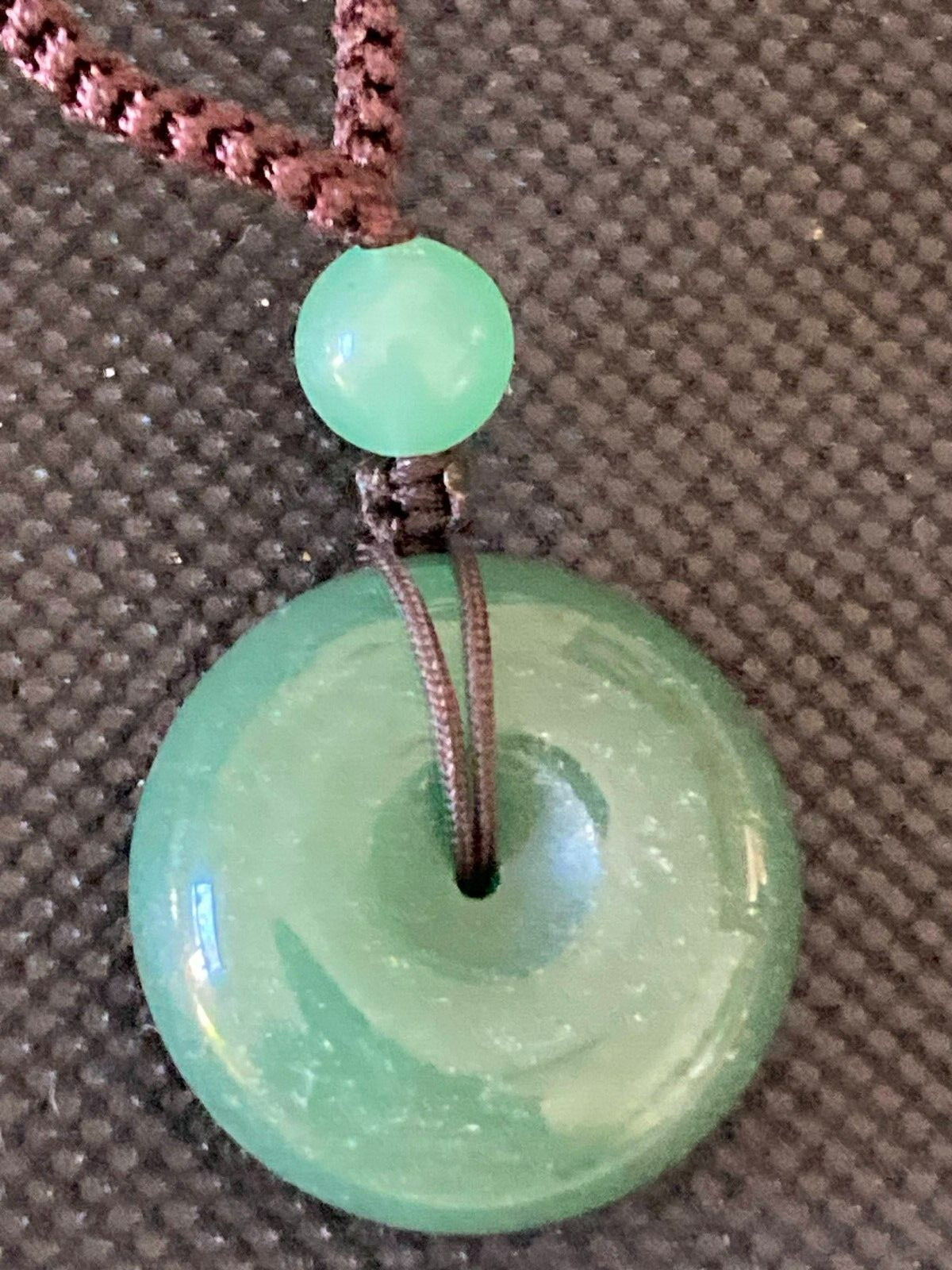 Necklace Carved Green Stone Pendant Circle and 3 stone beads woven with cord