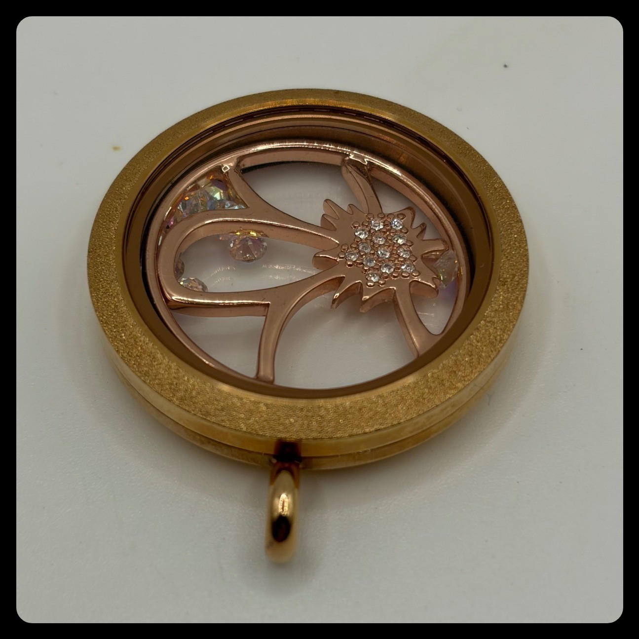 Origami Owl rose gold memory locket featuring a flower charm with crystal accent