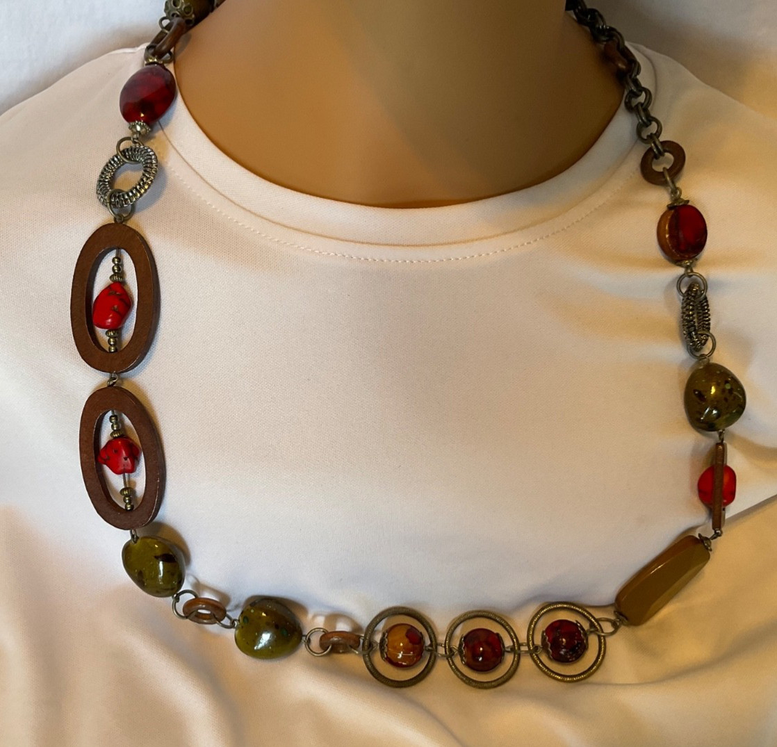 chicos 37” necklace featuring red, green and brown beads with geometric rings