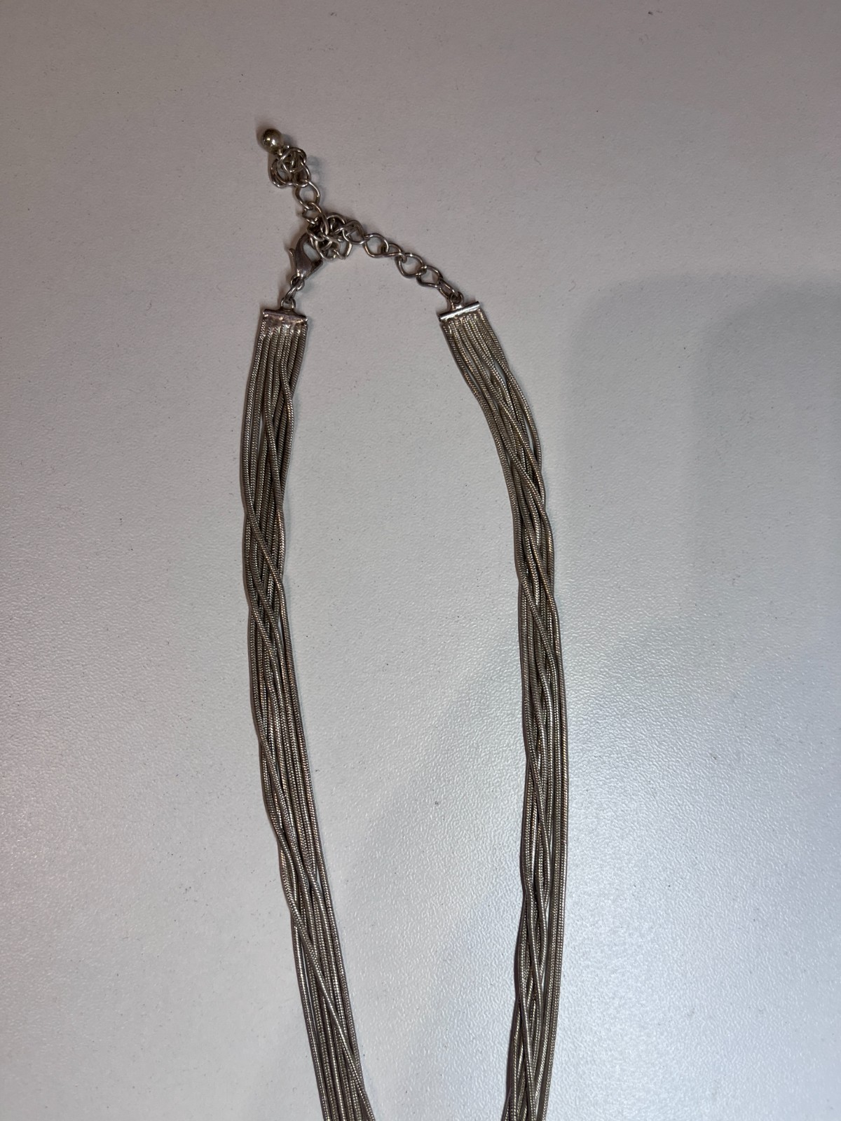 MULTI STRAND SILVER TONE CROSS OVER NECKLACE