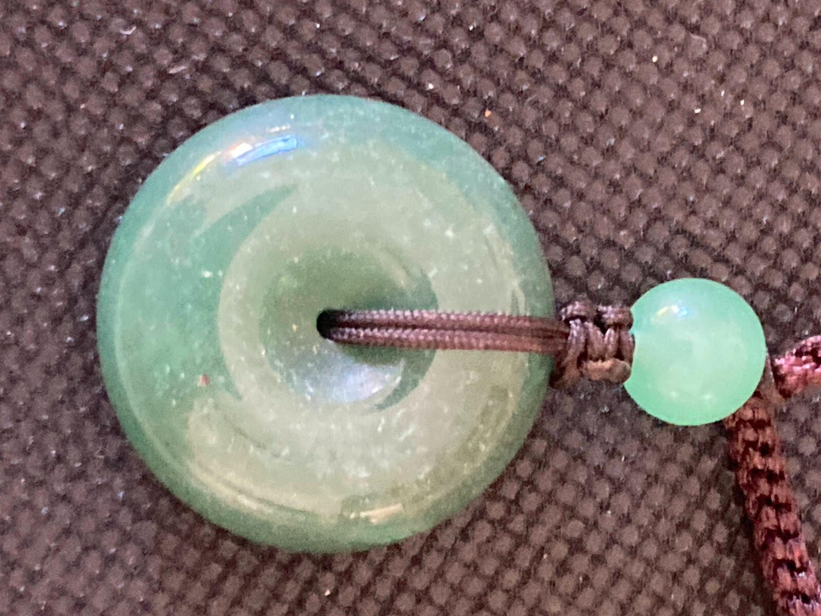 Necklace Carved Green Stone Pendant Circle and 3 stone beads woven with cord
