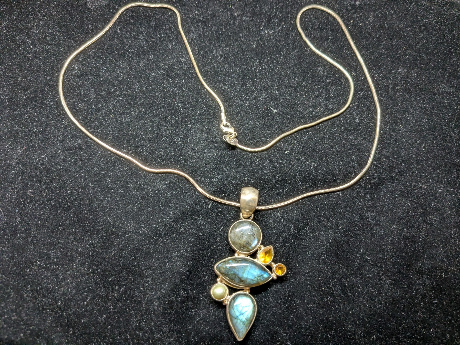 A Multi-stone cluster statement pendant necklace