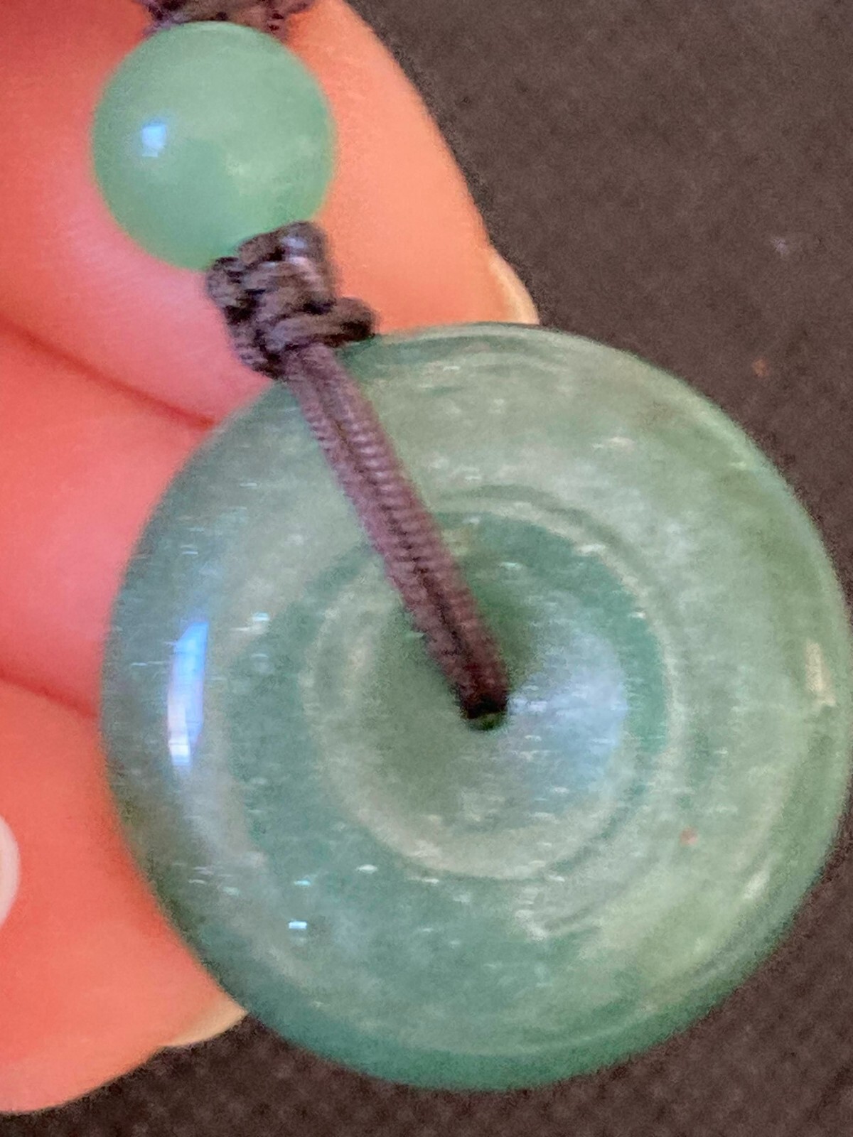 Necklace Carved Green Stone Pendant Circle and 3 stone beads woven with cord
