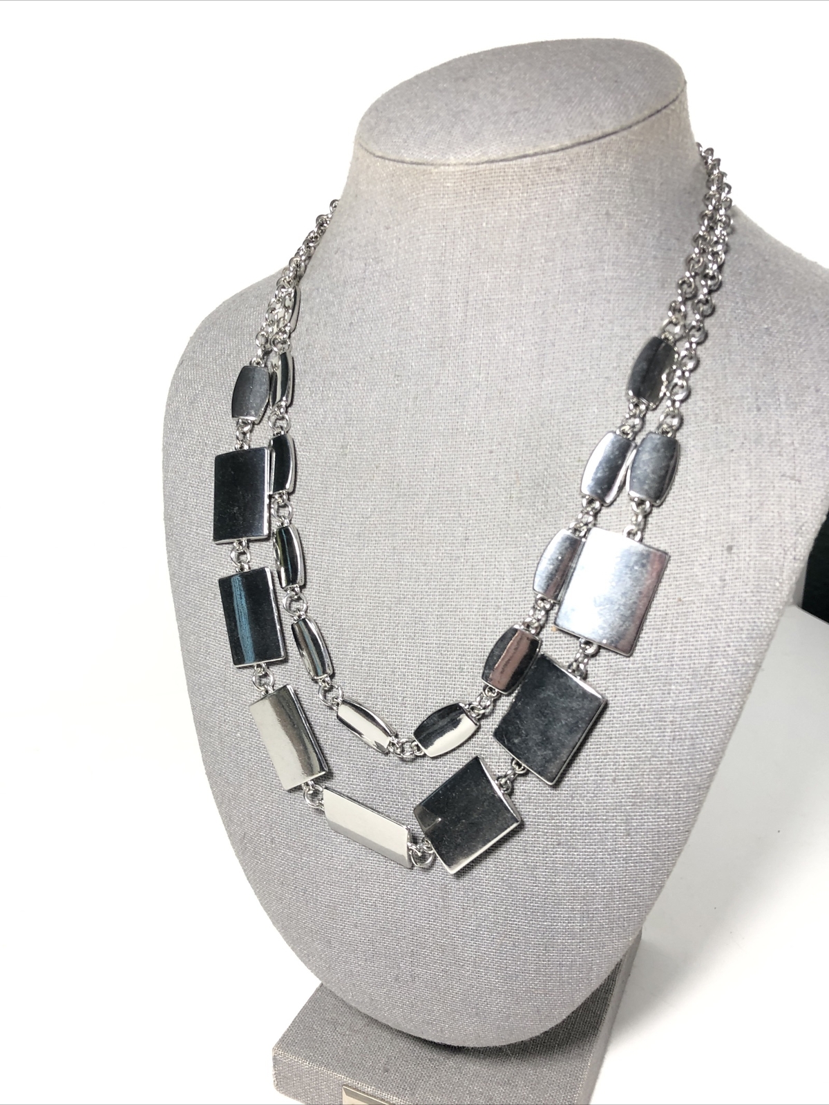 Women’s silver tone 18” double strand tier necklace. Silver rectangle charms.