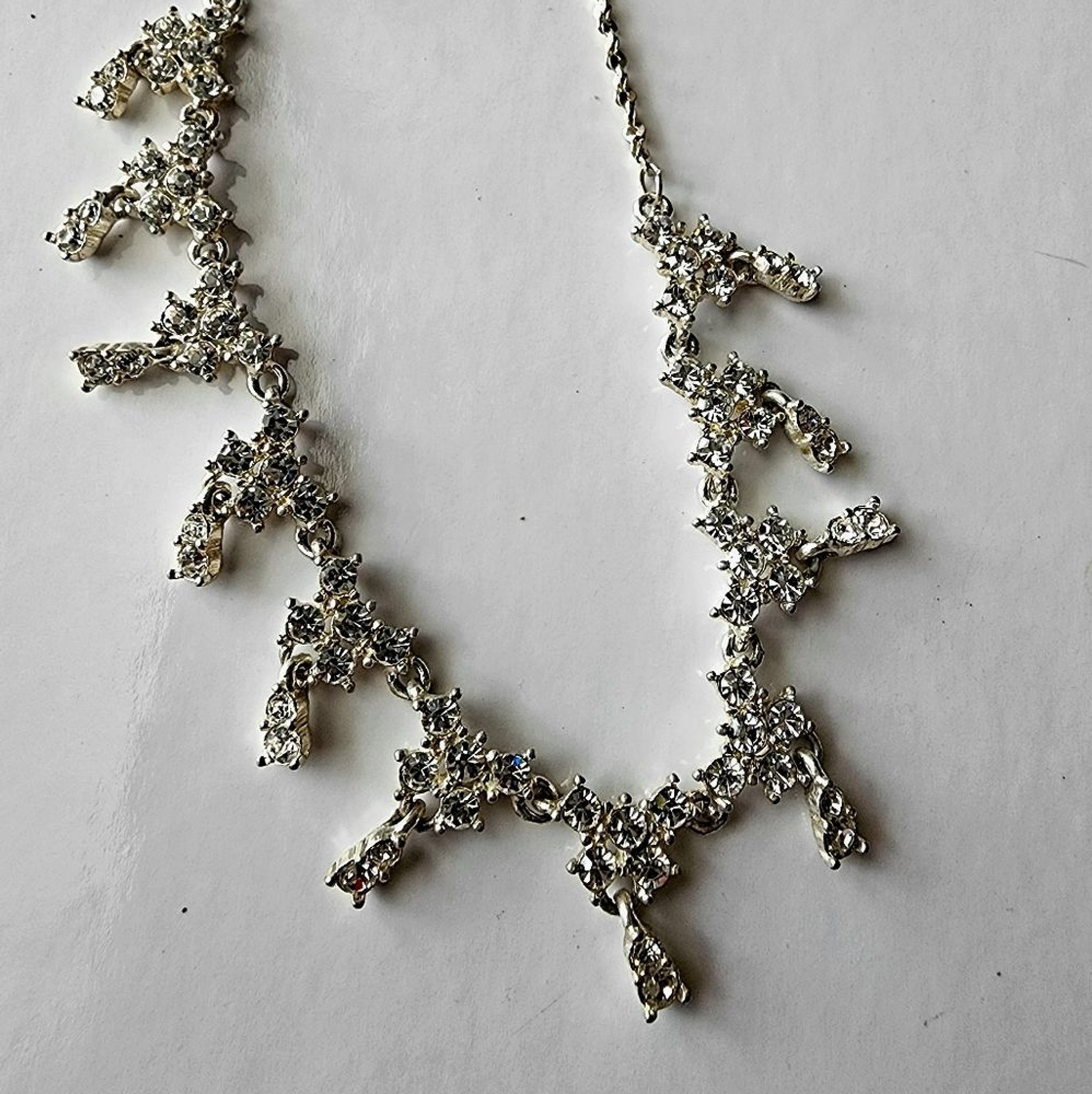 Silver tone necklace with prongs set white rhinestones round and square in shape