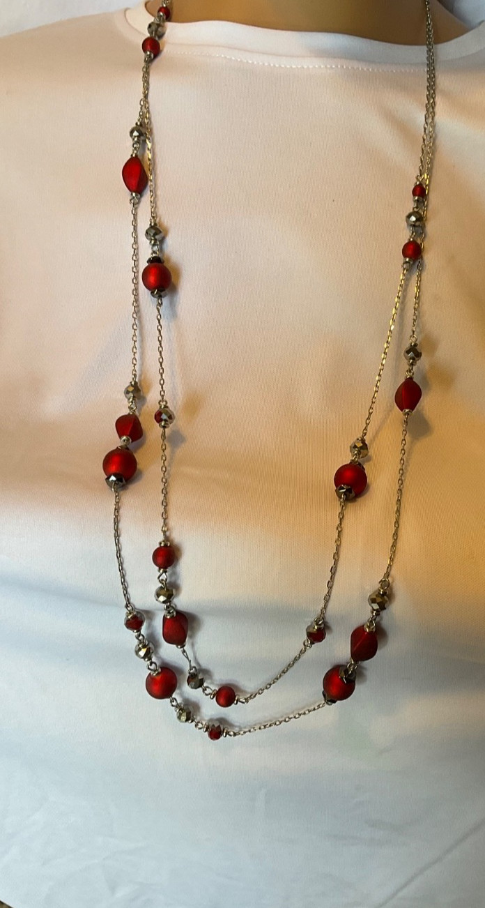 Marked “ruby red”. Necklace features red beads with glassy beads on silver chn