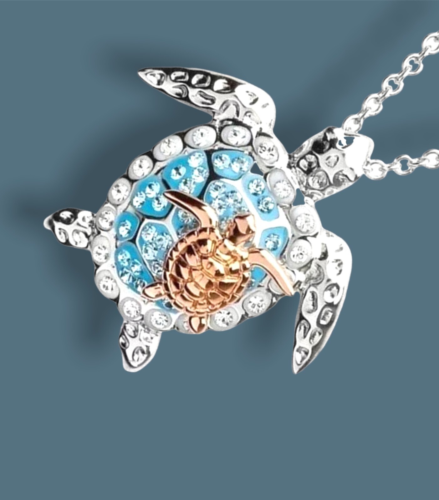 Silver and blue mother turtle with gold baby on back