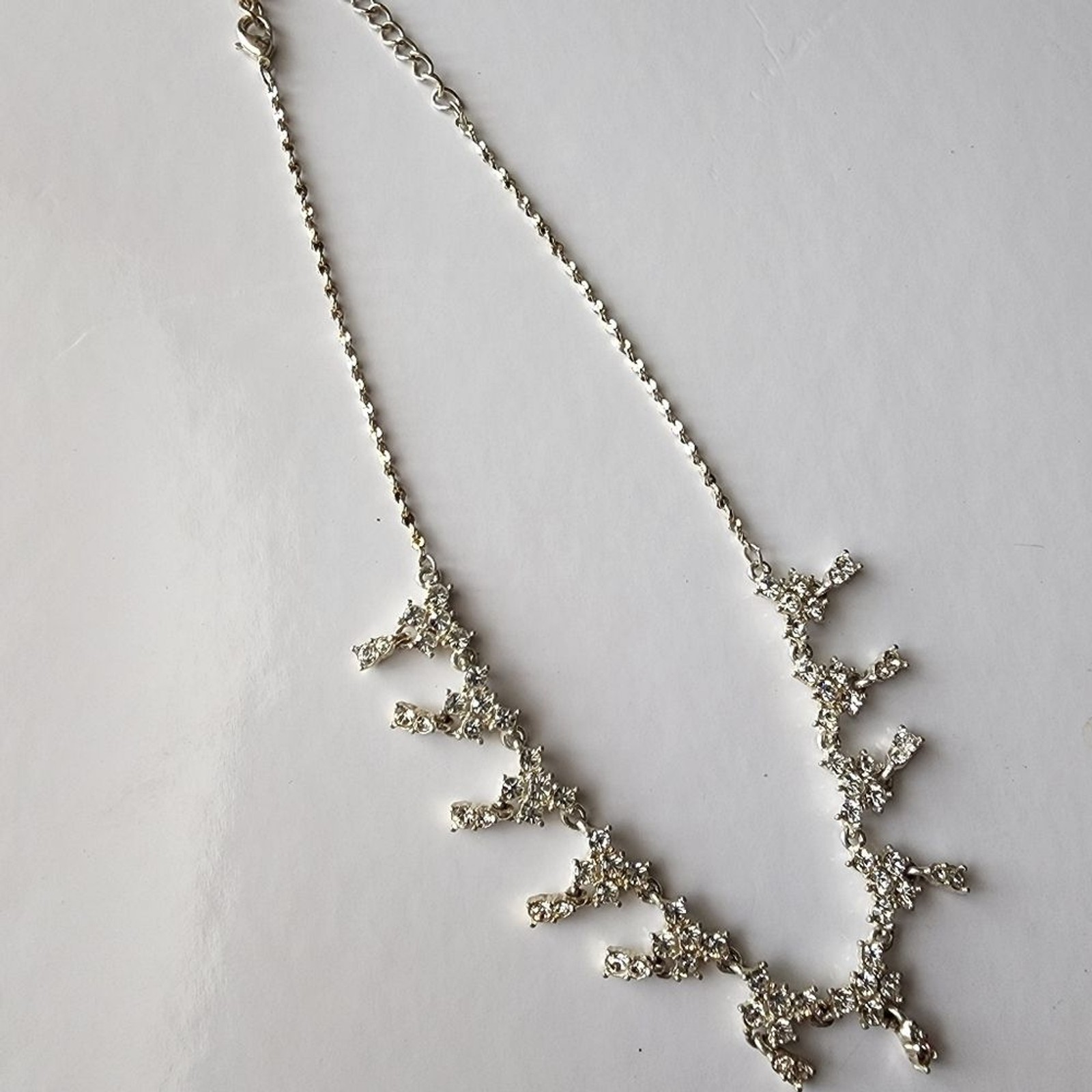 Silver tone necklace with prongs set white rhinestones round and square in shape
