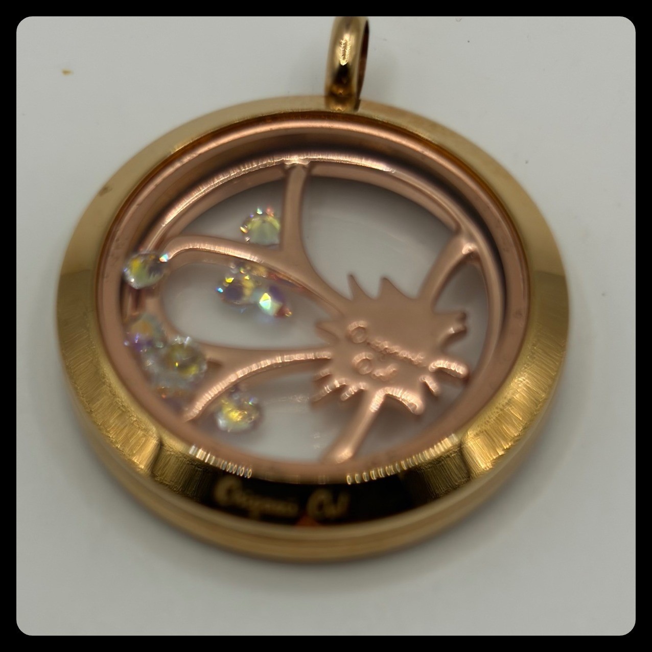 Origami Owl rose gold memory locket featuring a flower charm with crystal accent