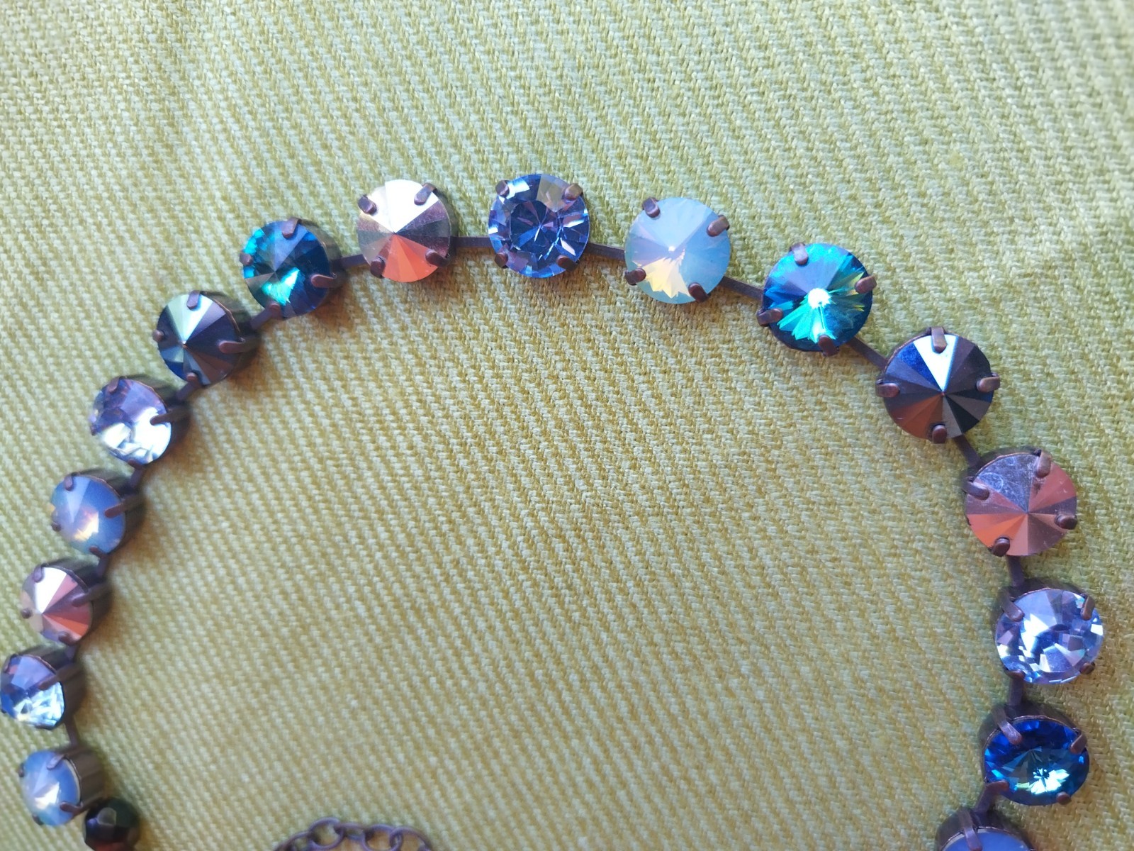 Soulful blue Sabika necklace features violet, midnight blue, opal, metallic
