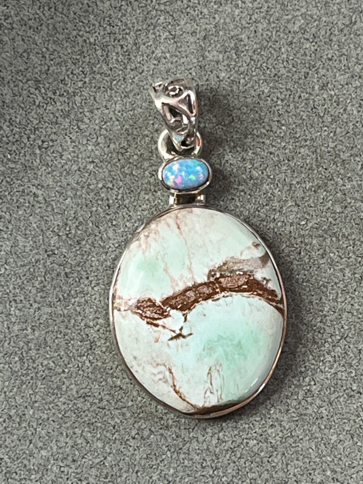 Small Lab Created Opal & Light Blue w Brown Veins Oval Stone in 925 Silver Frame