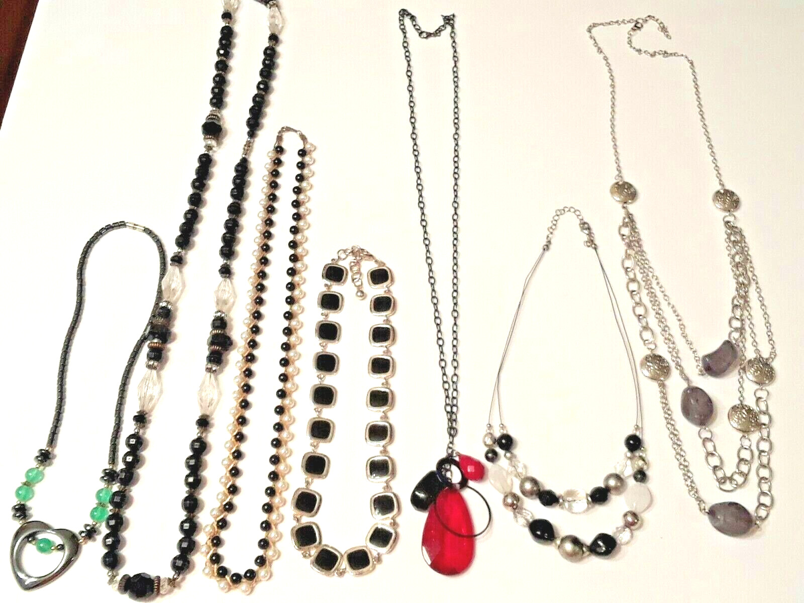 heart pendant, black beads, plastic + metal. you get all 7 beautiful necklaces
