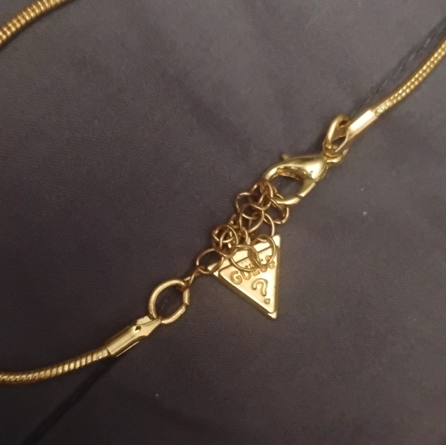 GUESS Gold Tone Snake Chain Necklace, Black Glass Rectangle Tassel Pendant