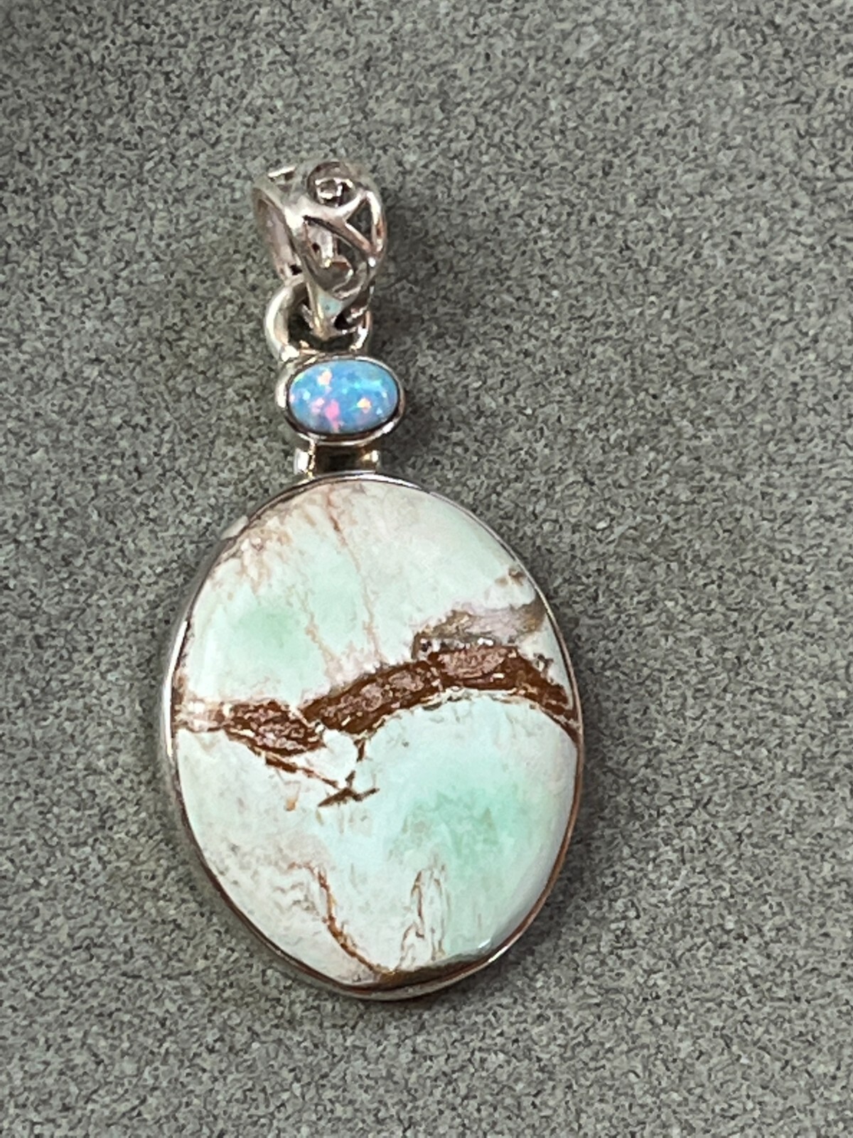 Small Lab Created Opal & Light Blue w Brown Veins Oval Stone in 925 Silver Frame