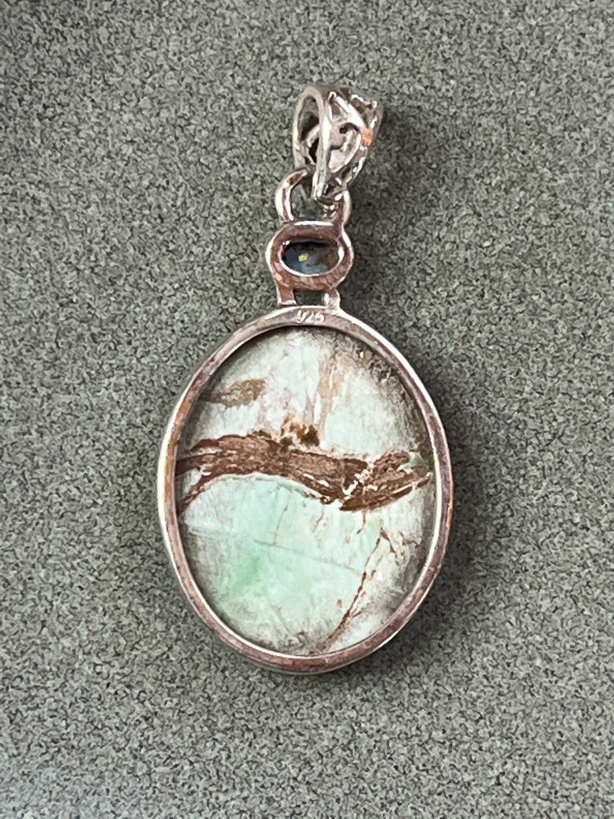 Small Lab Created Opal & Light Blue w Brown Veins Oval Stone in 925 Silver Frame