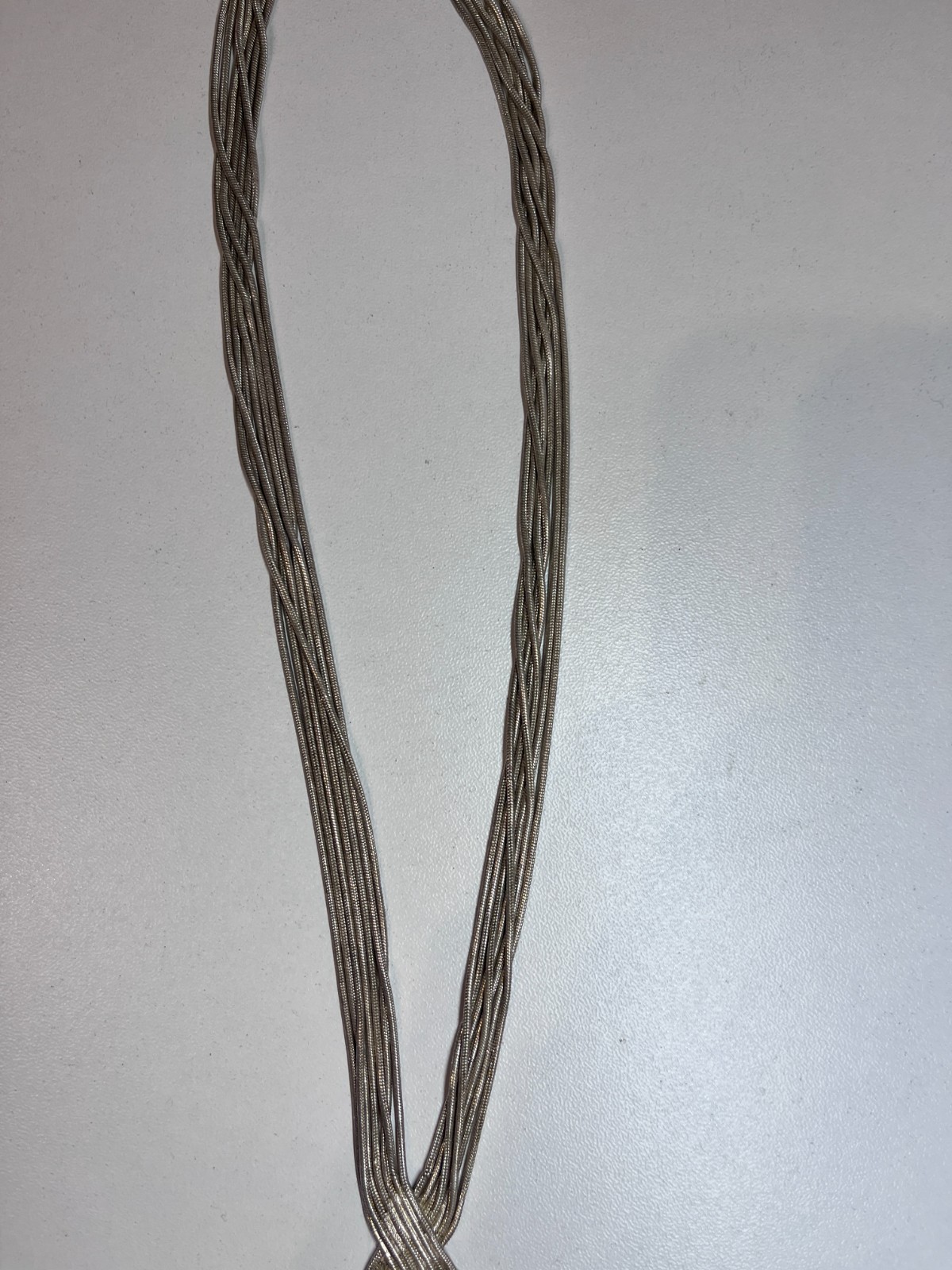 MULTI STRAND SILVER TONE CROSS OVER NECKLACE