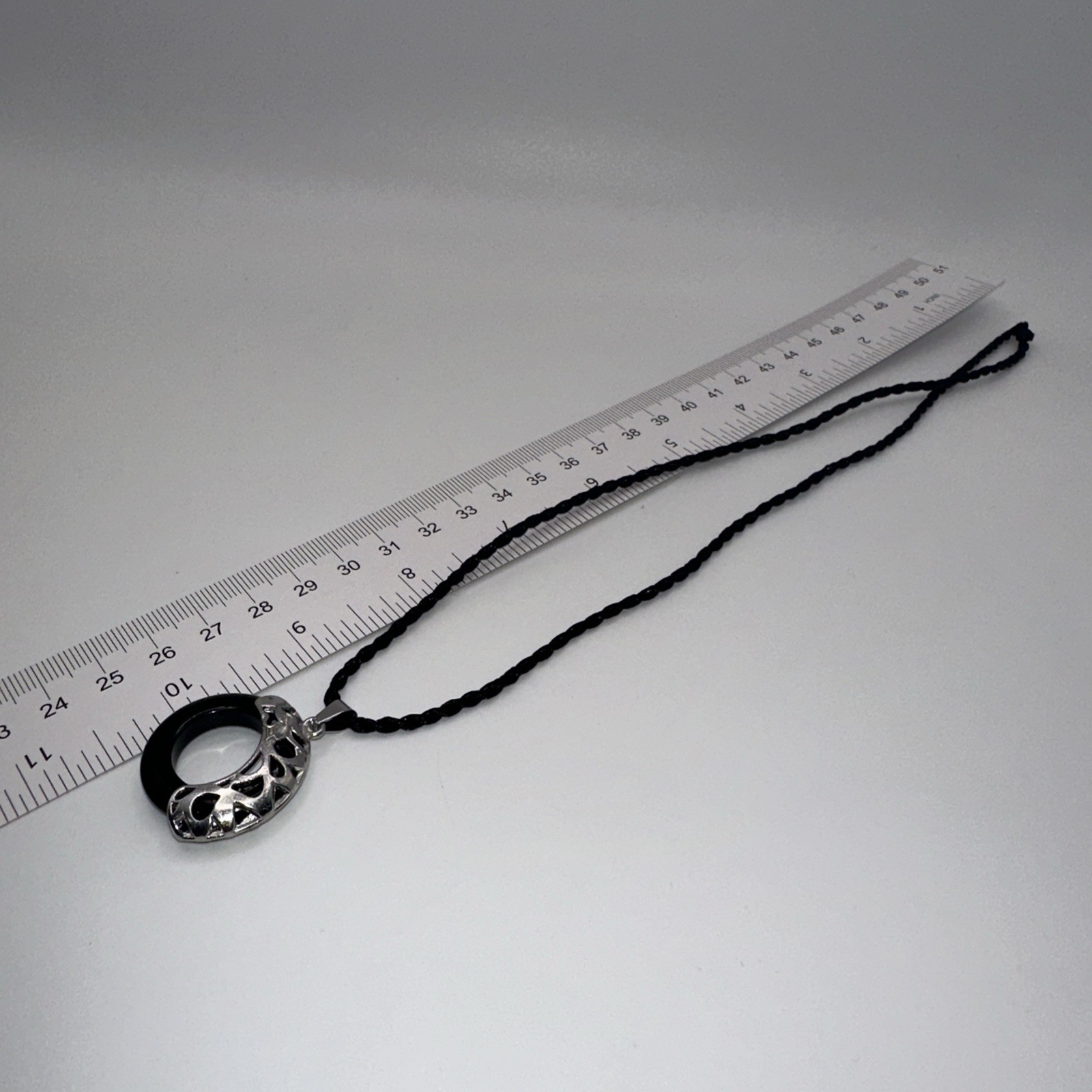 Black Donut-Shaped Stone Necklace with Silver Woven Rope Chain