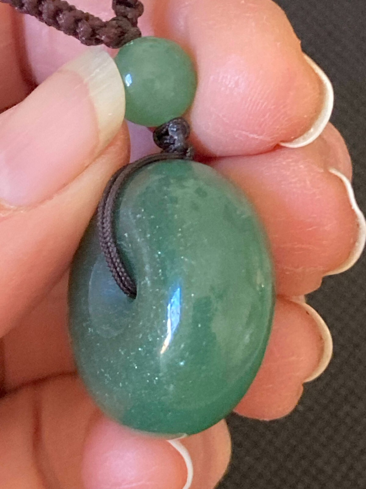 Necklace Carved Green Stone Pendant Circle and 3 stone beads woven with cord