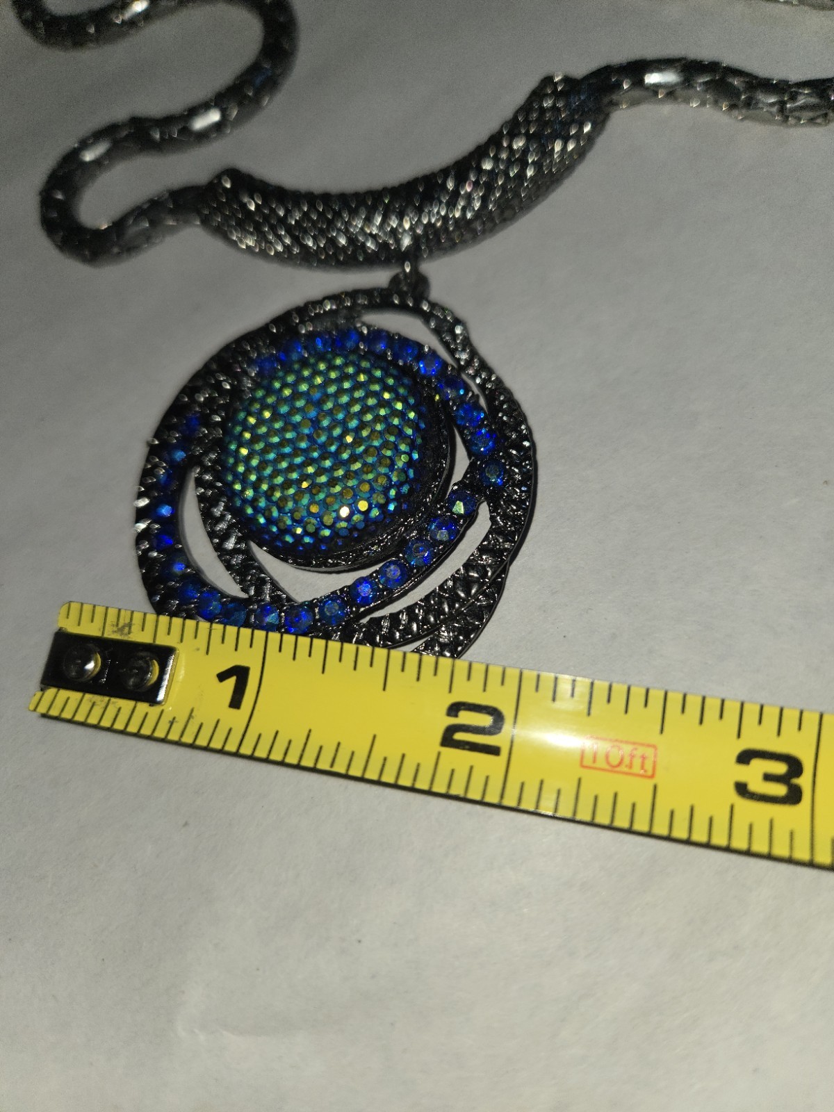 Gunmetal finished Vibrant Green And Blue Style Center Sortounded With Crystal