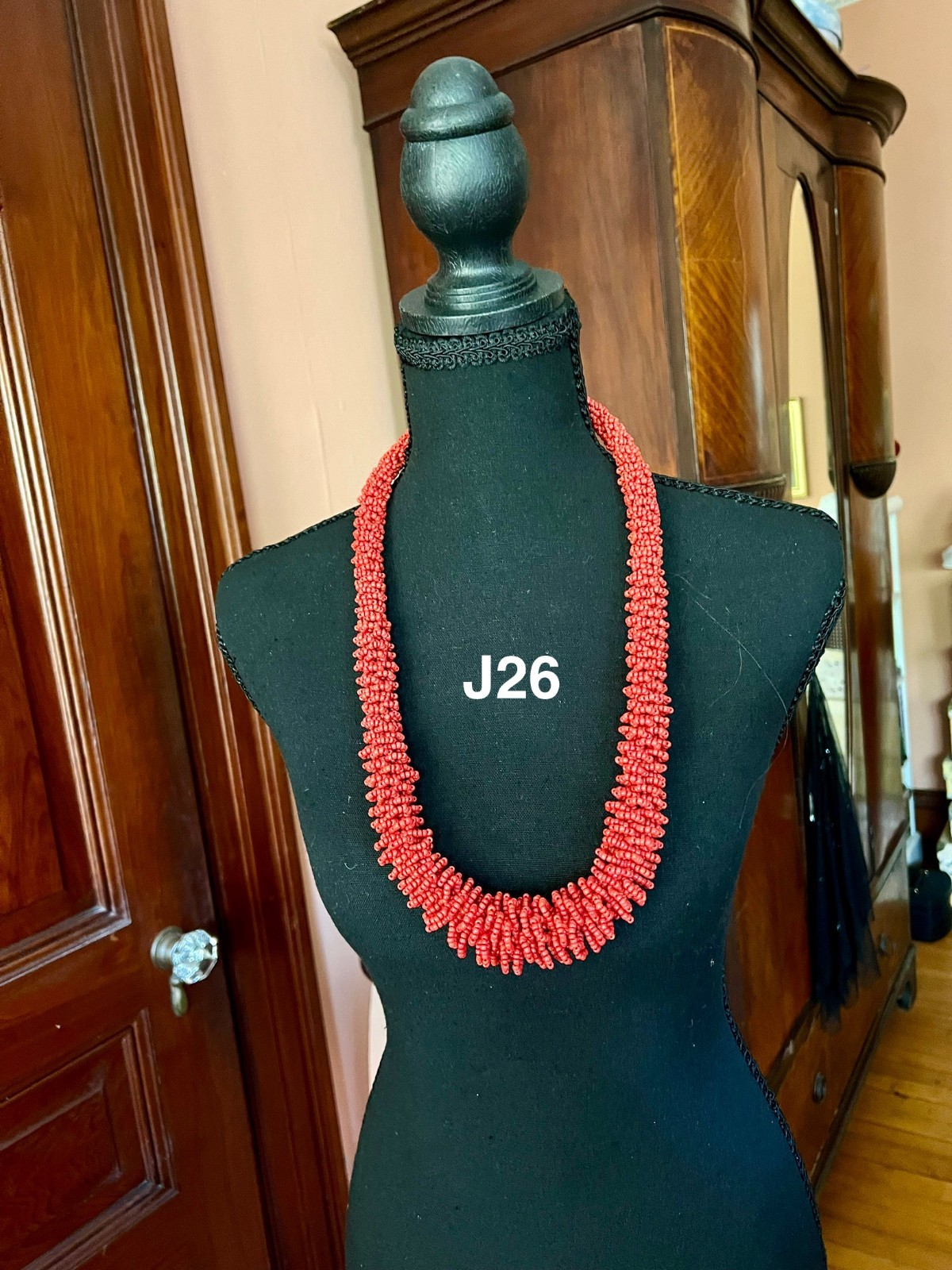 This coral seed bead necklace features a textured, multi-strand cluster design